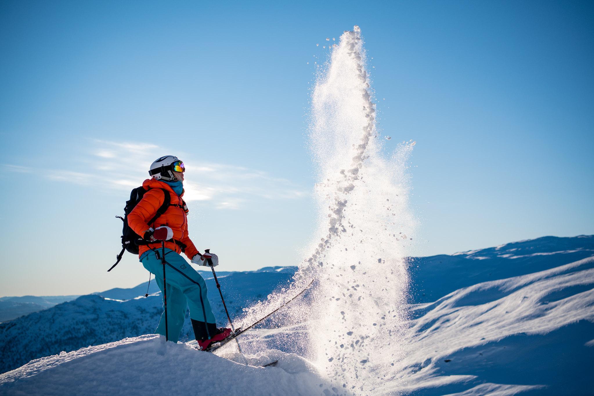 A skiier flicks snow in the Norway ski resort of Myrkdalen