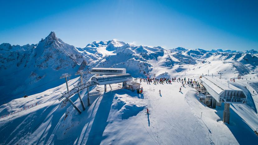 Skiers at top of mountains in Courchevel ski resort